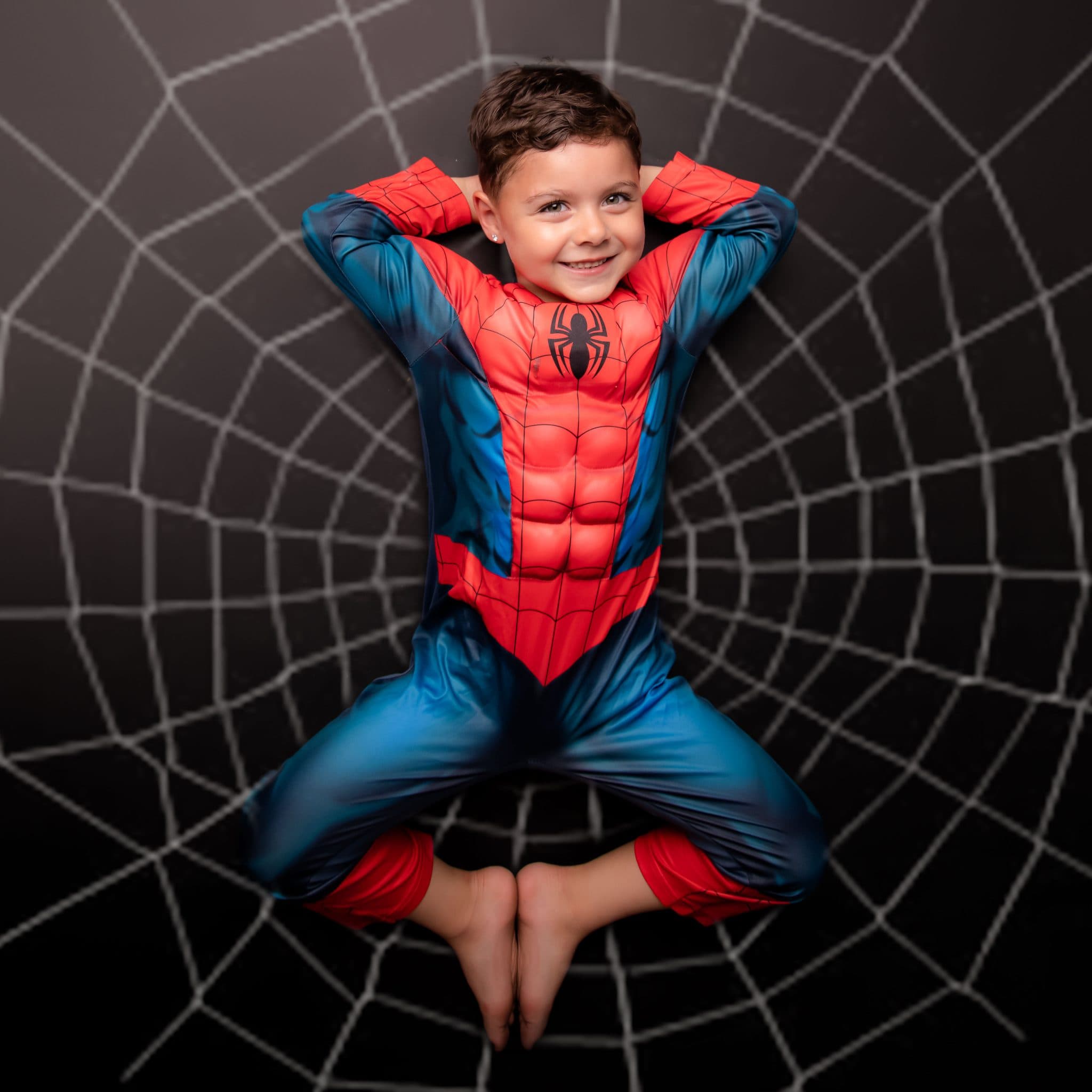 Spider-themed superhero portrait on a graphic black backdrop.