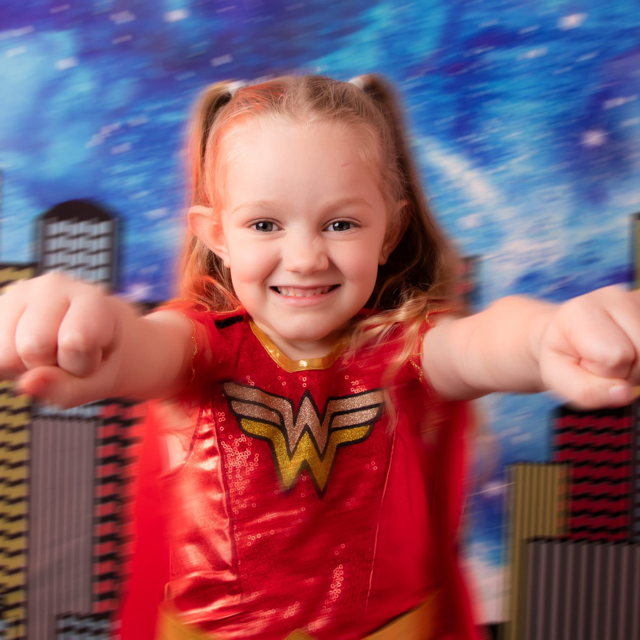 Action-inspired superhero pose in studio.